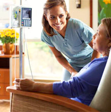 health staff talking to senior patient